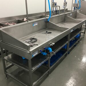 Fish cleaning table on dock with running water and cutting board 