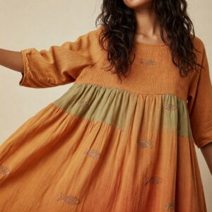 Boho-style dress with subtle fish embroidery, representing Fish Hippie fashion in earthy orange and green tones