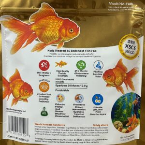 A goldfish in a glass bowl eating small fish food pellets near the surface.