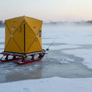  Illustration of an ice fishing sled being used to transport an ice fishing shelter across a frozen lake.
