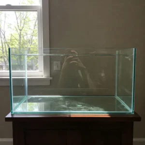 Illustration depicting common maintenance tasks for a 25 gallon fish tank, like water changes and algae cleaning.