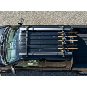 An overhead shot of a roof-mounted fishing rod rack on a truck, designed to carry long rods without interfering with the truck bed or tailgate.