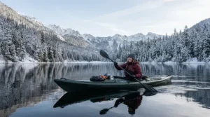 A kayak angler equipped with weather-resistant fishing pants for cold weather fishing on a cold reservoir.