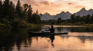 Angler on a kayak wearing a full coverage hooded design among popular performance fishing shirts