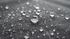 Detail view of water droplets sliding off the advanced fabric of high quality performance fishing shirts